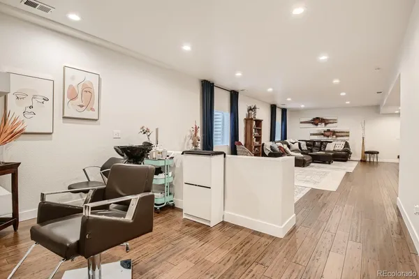 a living room with furniture and a wooden floor
