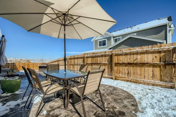 a patio with a table and chairs