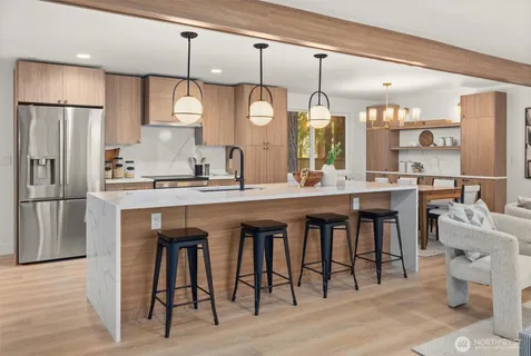 a kitchen with a table chairs refrigerator and microwave