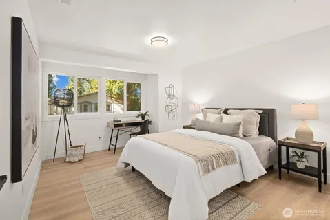 a bedroom with a bed and a table