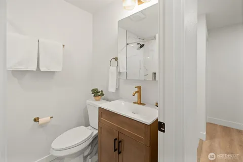 a bathroom with a sink a toilet and vanity