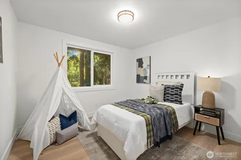 a bedroom with a bed and a window