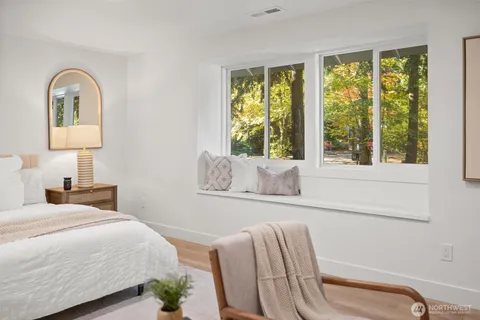 a bedroom with furniture and a window