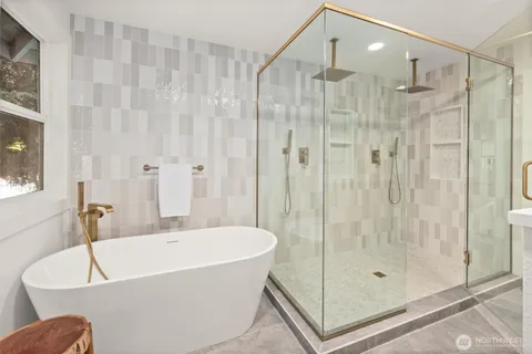 a bathroom with a tub and shower
