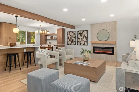 a living room with fireplace furniture and a large window