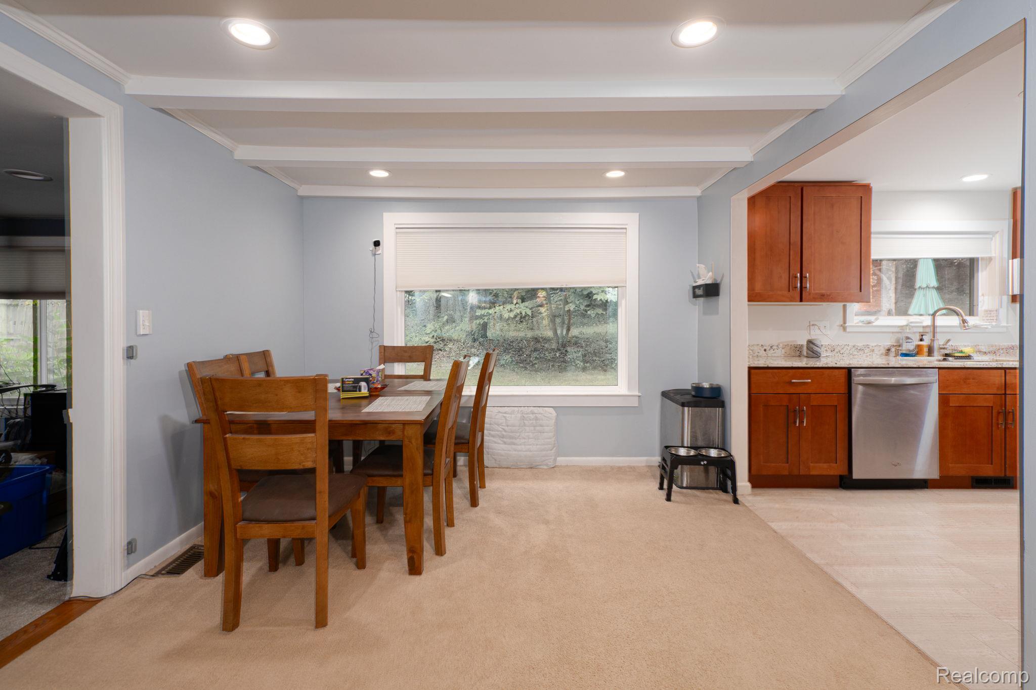 1775 Porter Road White Lake, MI 48383 - Photo 19 of 33 Recessed lighting, exposed ceiling beams, a large window, wood-finish cabinetry, and stainless steel appliances