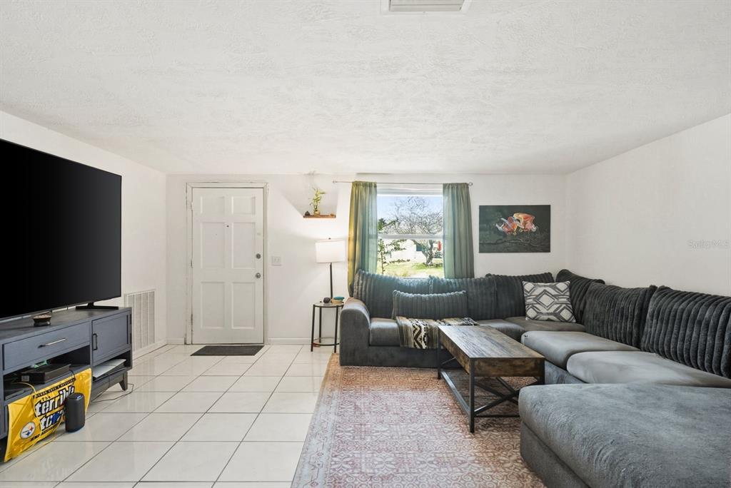 4276 Rudder Way New Port Richey, FL 34652 - Photo 3 of 29 a living room with furniture and a flat screen tv