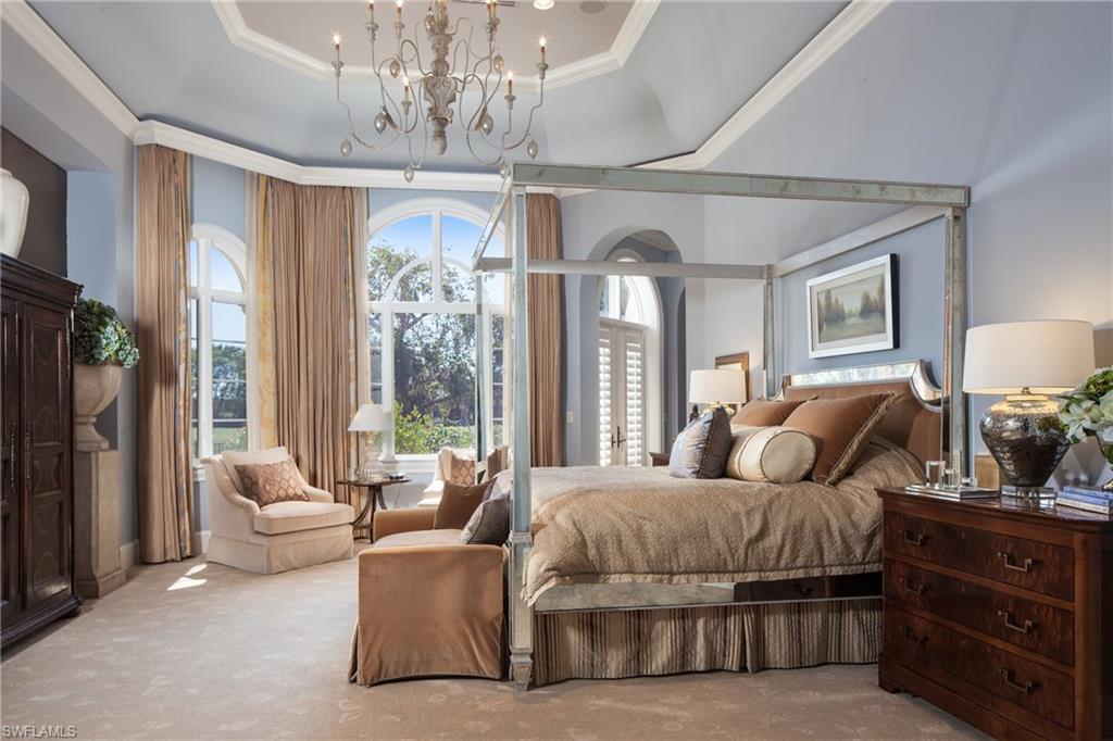 2152 Canna Way Naples, FL 34105 - Photo 16 of 25 a bedroom with double bed and a chandelier