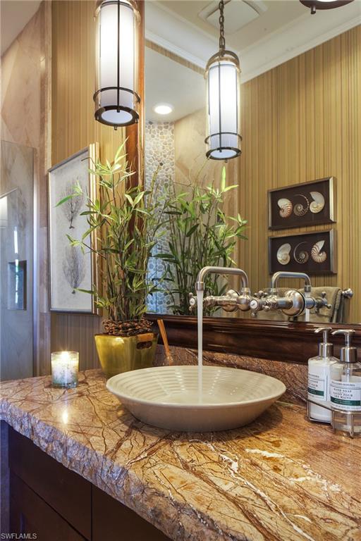 2152 Canna Way Naples, FL 34105 - Photo 21 of 25 a view of a kitchen with granite countertop a sink and a wooden floor