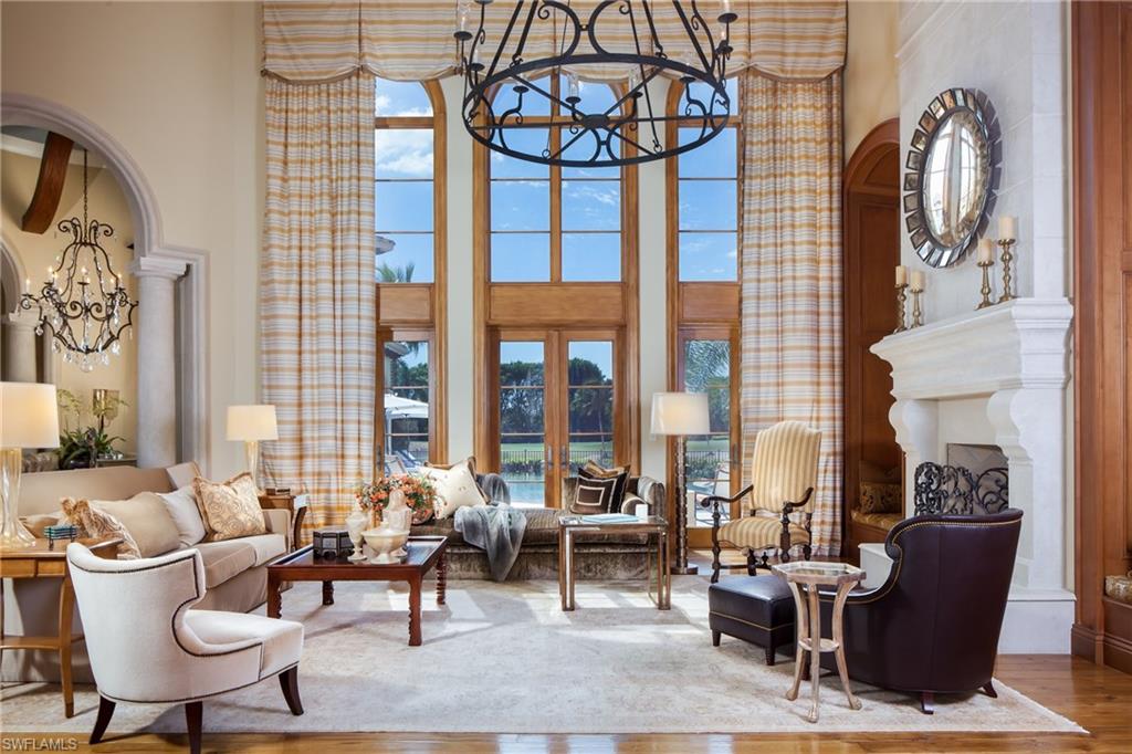 2152 Canna Way Naples, FL 34105 - Photo 6 of 25 a living room with fireplace furniture and a large window