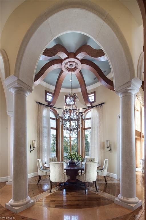 2152 Canna Way Naples, FL 34105 - Photo 8 of 25 a dining room with wooden floor and large windows