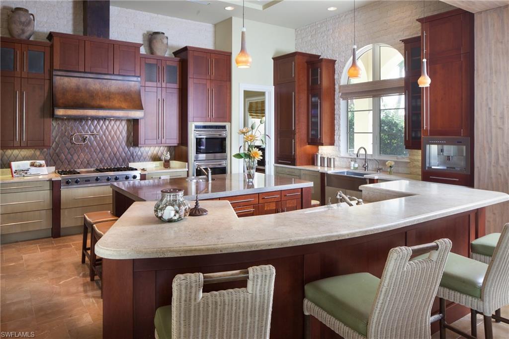 2152 Canna Way Naples, FL 34105 - Photo 10 of 25 a dining room with stainless steel appliances granite countertop a dining table and chairs