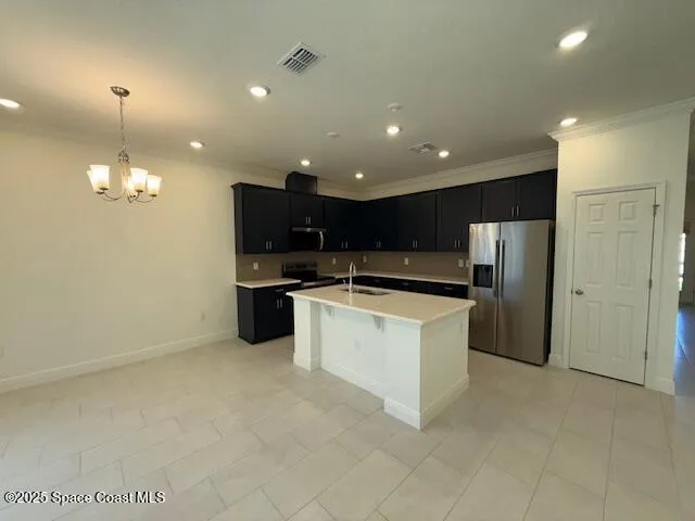 a large kitchen with a sink and stainless steel appliances