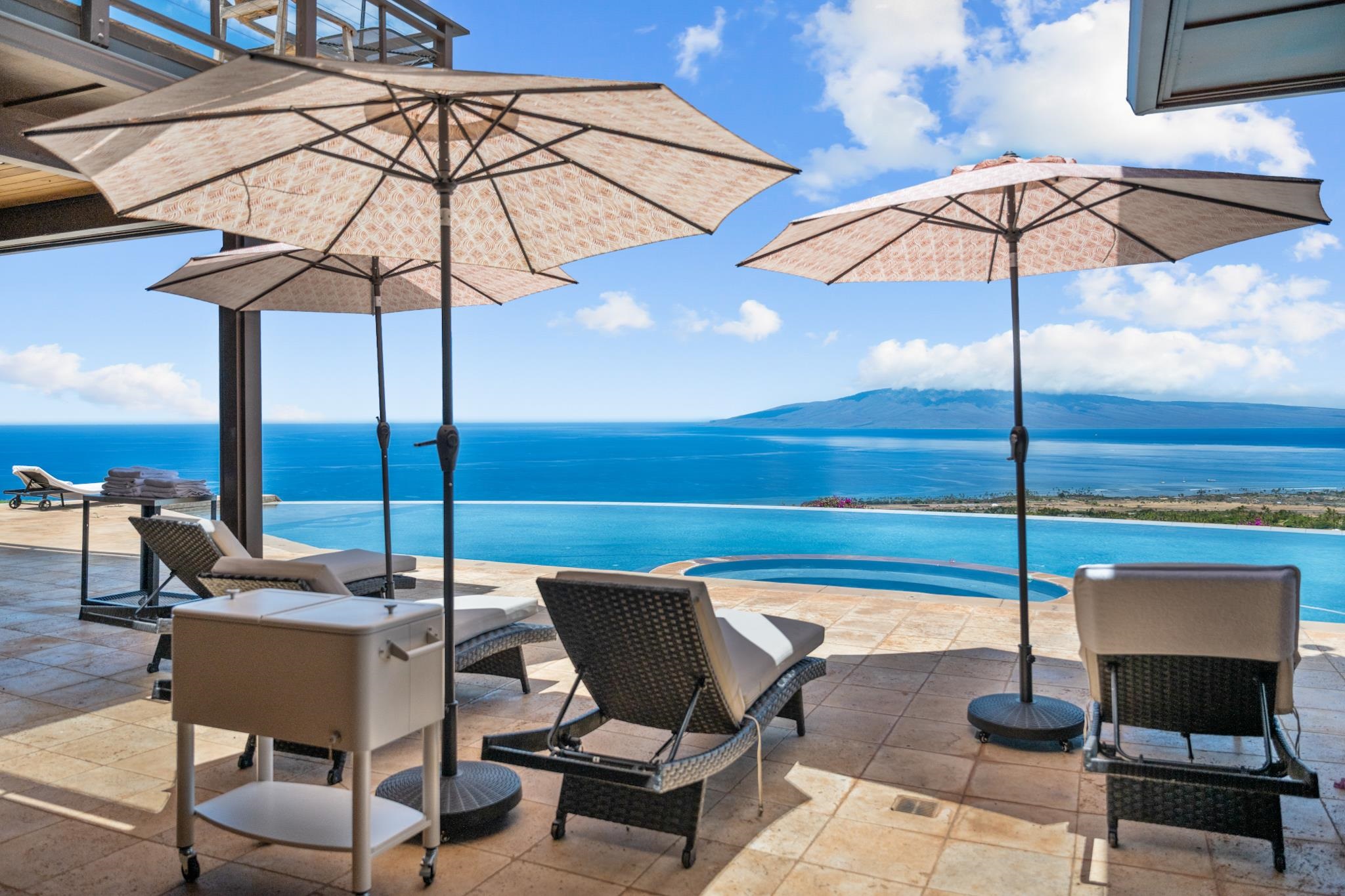 a view of a terrace with chairs and an umbrella
