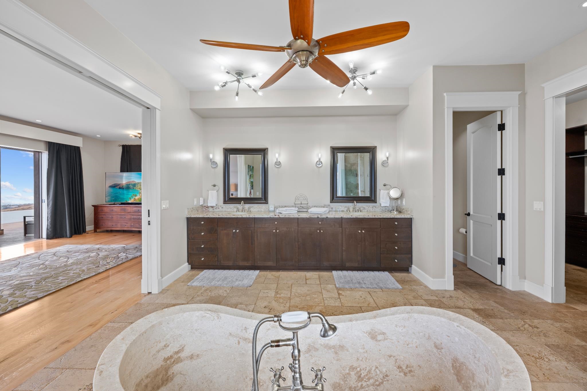 554 Punakea Loop, Unit A Lahaina, HI 96761 - Photo 29 of 49 a spacious bedroom with a large bed a chandelier and closet