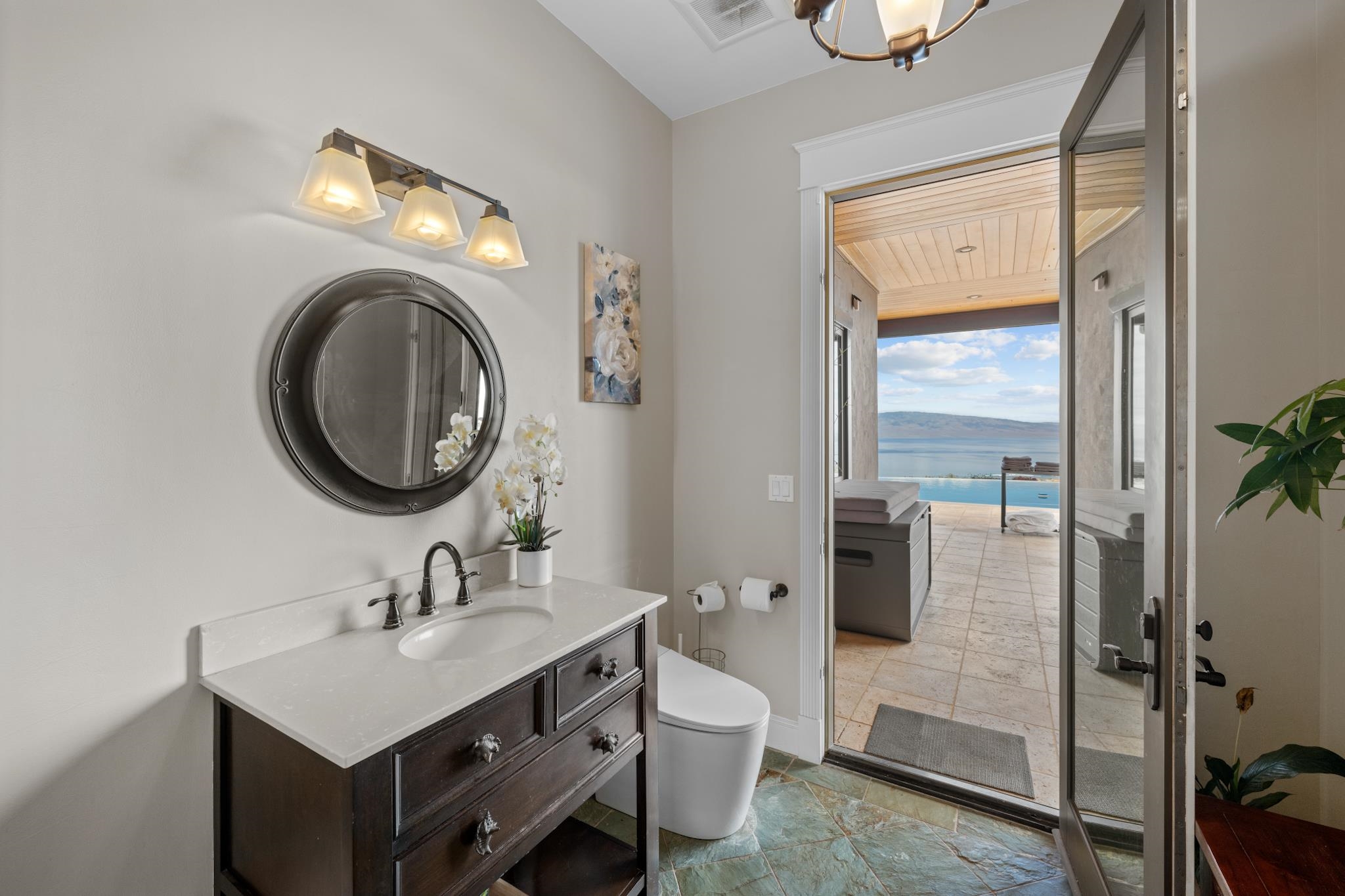 554 Punakea Loop, Unit A Lahaina, HI 96761 - Photo 32 of 49 a bathroom with a toilet a sink and a mirror
