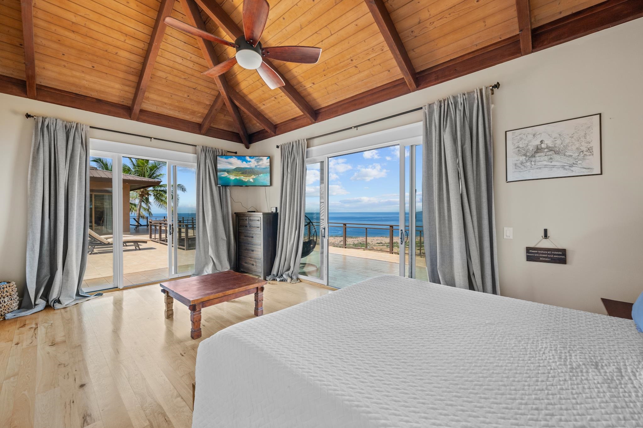 554 Punakea Loop, Unit A Lahaina, HI 96761 - Photo 36 of 49 a bedroom with furniture and a large window