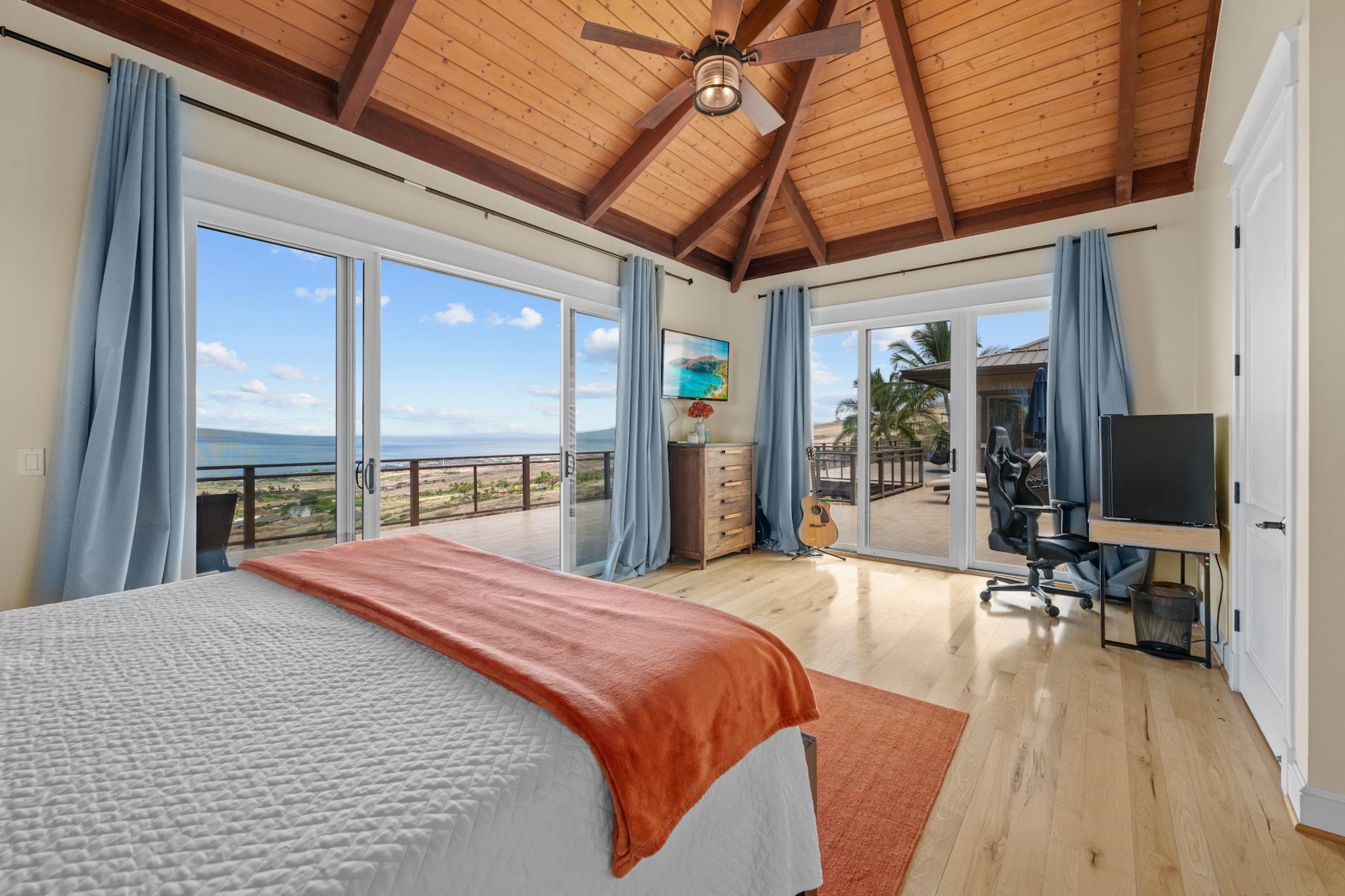 554 Punakea Loop, Unit A Lahaina, HI 96761 - Photo 39 of 49 a large bedroom with a bed and wooden floor