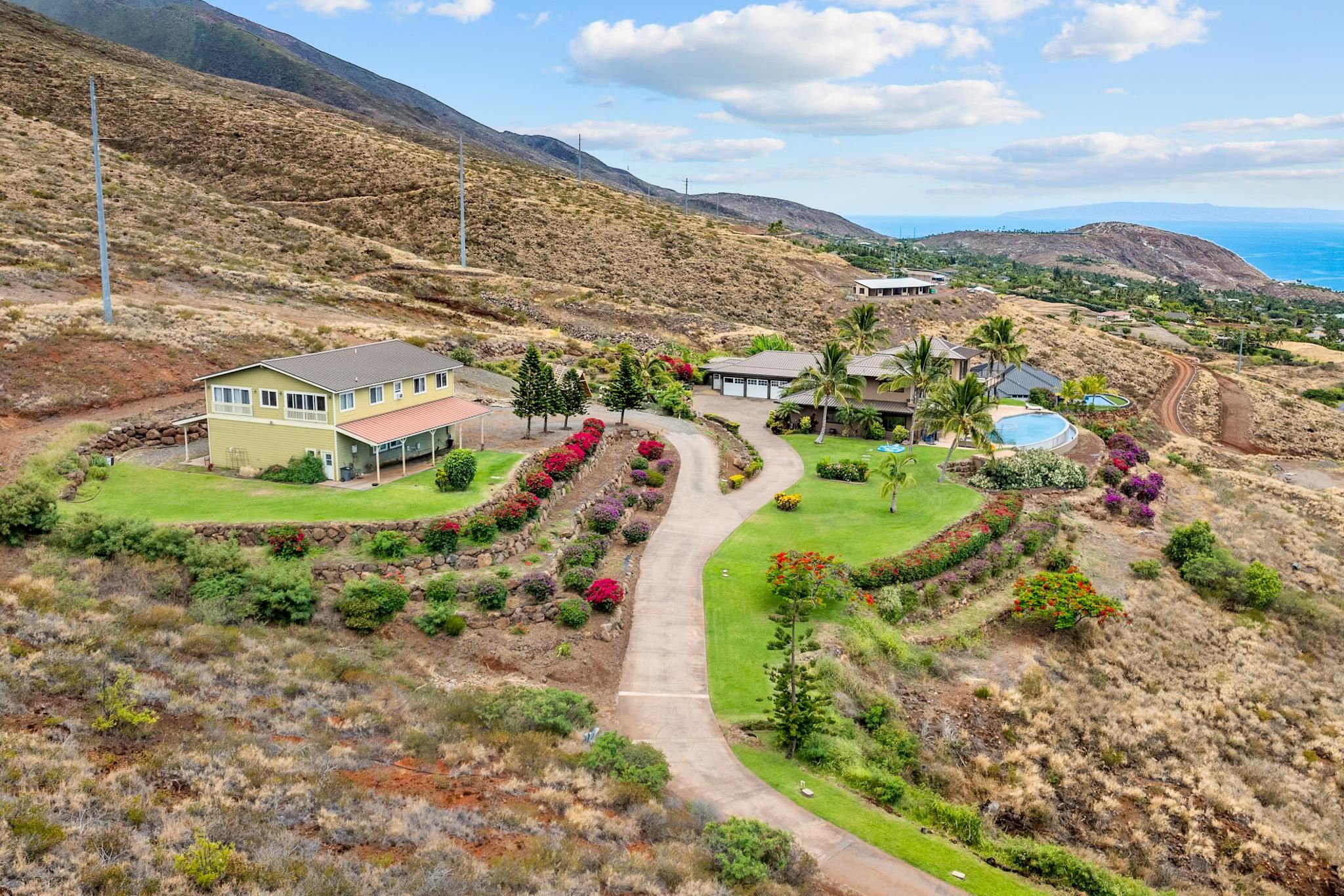 554 Punakea Loop, Unit A Lahaina, HI 96761 - Photo 5 of 49 a view of a multi story residential apartment building with a yard