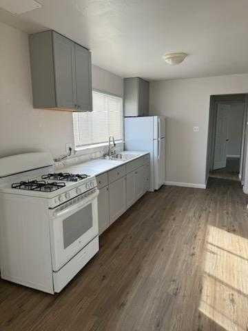a kitchen with a stove a sink and a refrigerator