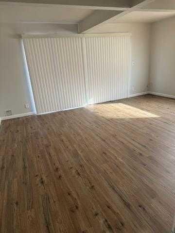 an empty room with wooden floor