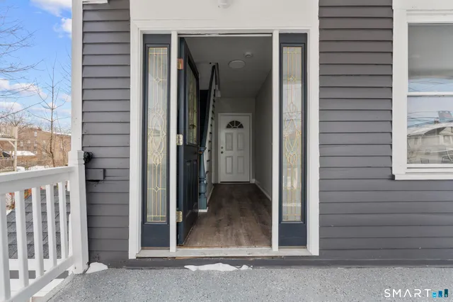 a view of a porch with a door and a window
