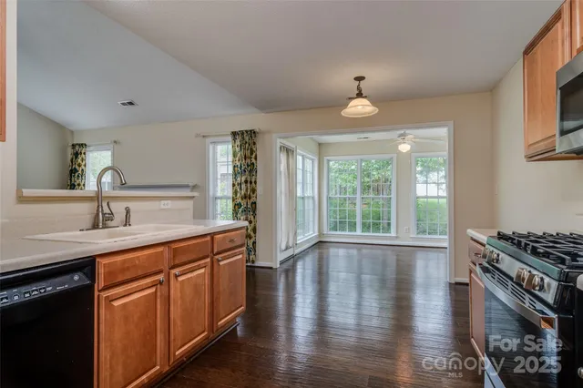 a kitchen with stainless steel appliances a sink stove and cabinets