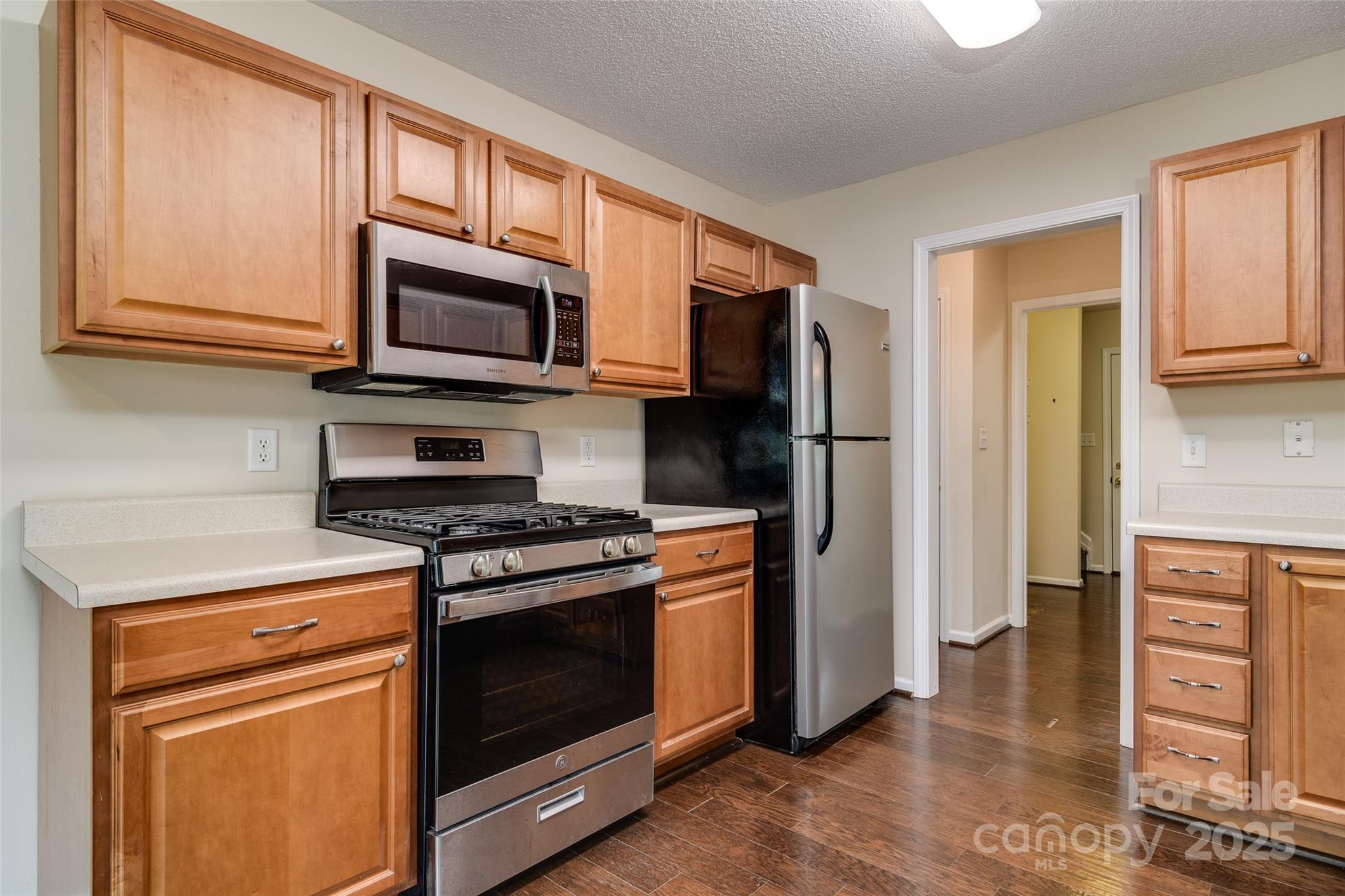 395 Running Briar Road Fletcher, NC 28732 - Photo 14 of 33 a kitchen with stainless steel appliances granite countertop a stove microwave and refrigerator