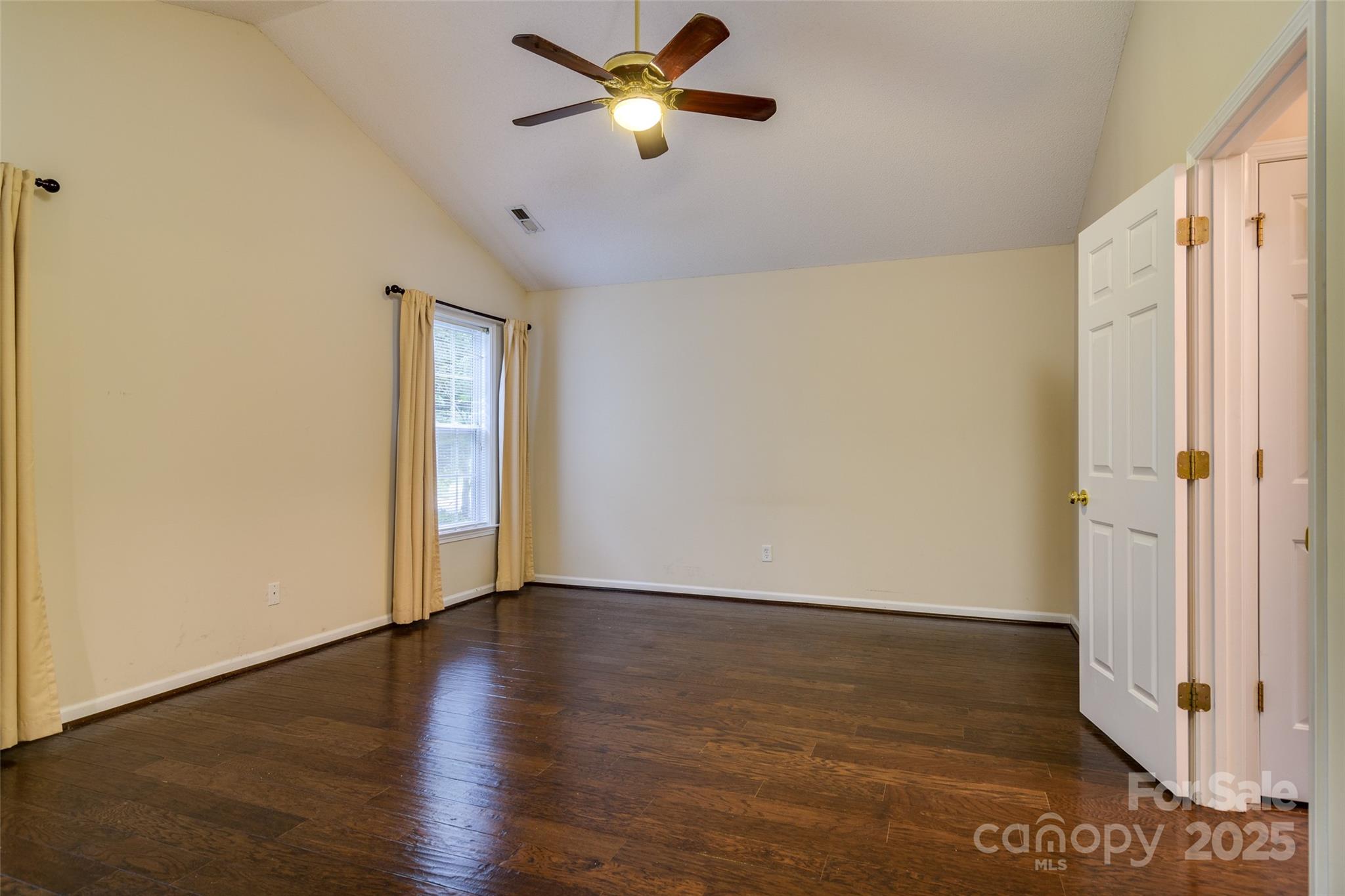 395 Running Briar Road Fletcher, NC 28732 - Photo 16 of 33 an empty room with wooden floor fan and windows