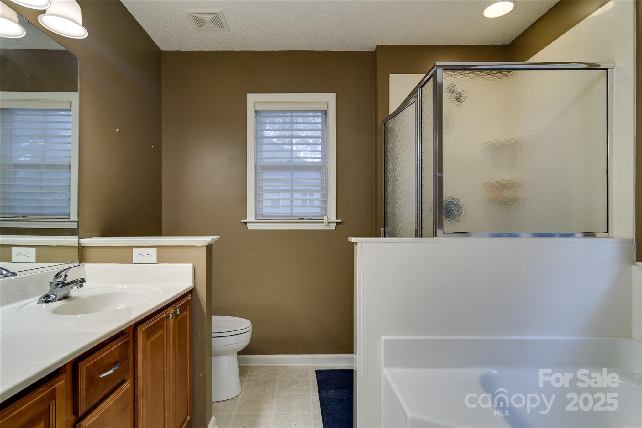 395 Running Briar Road Fletcher, NC 28732 - Photo 18 of 33 a bathroom with a sink a toilet and shower