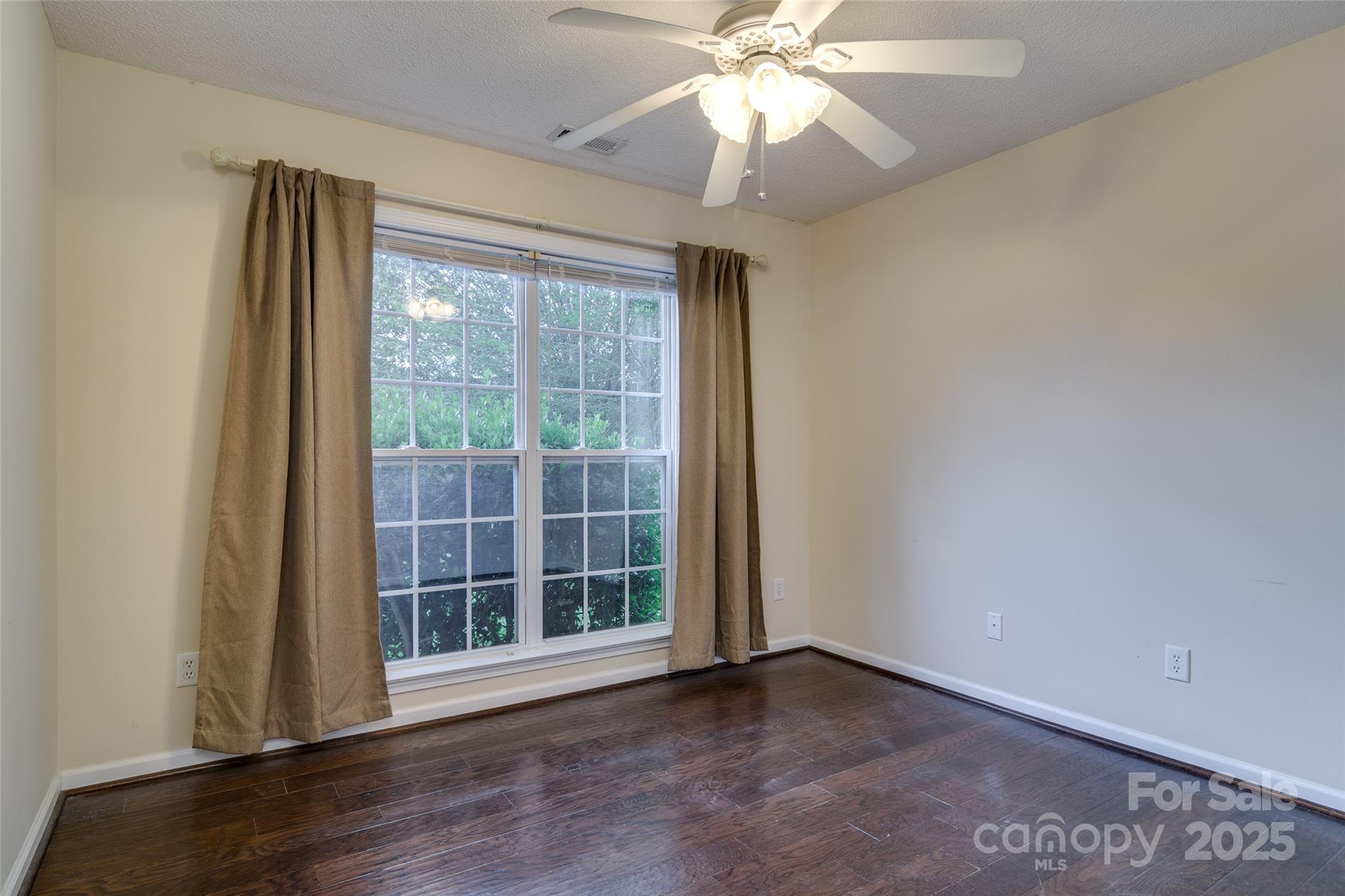395 Running Briar Road Fletcher, NC 28732 - Photo 22 of 33 an empty room with wooden floor fan and windows