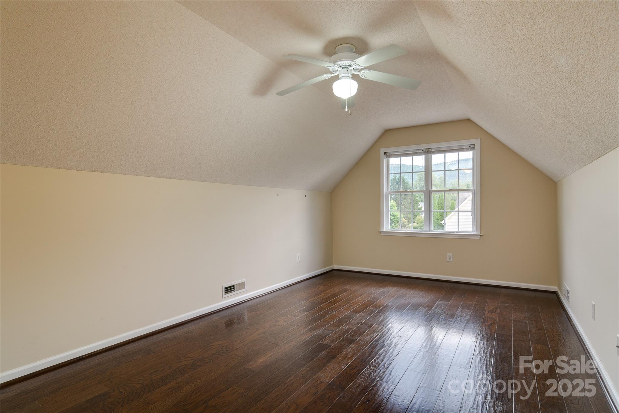 395 Running Briar Road Fletcher, NC 28732 - Photo 27 of 33 an empty room with wooden floor and windows
