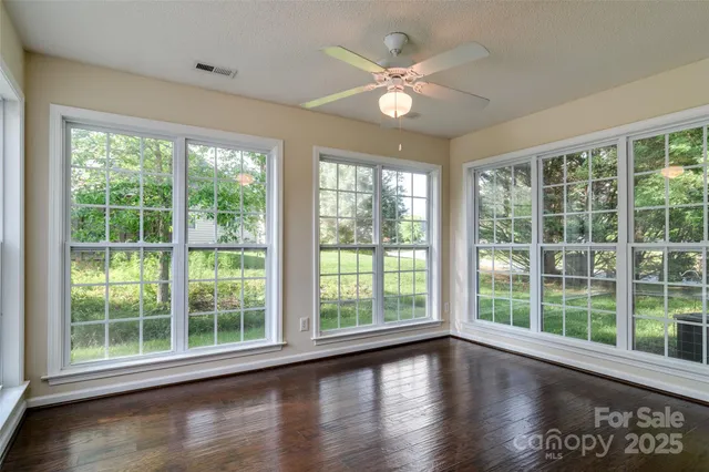 a view of a livingroom with furniture wooden floor and a large window