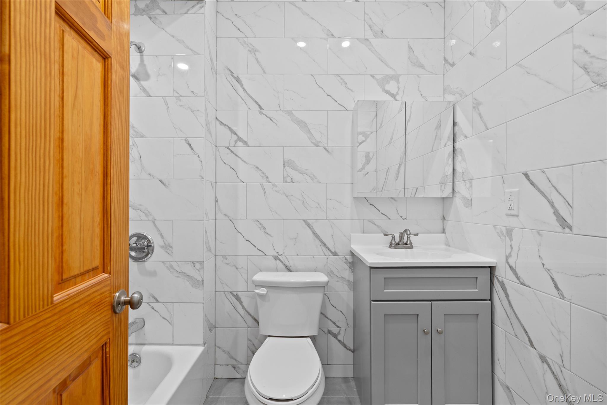 168-31 Hillside Avenue, Unit F Queens, NY 11432 - Photo 12 of 16 a bathroom with a toilet sink and shower