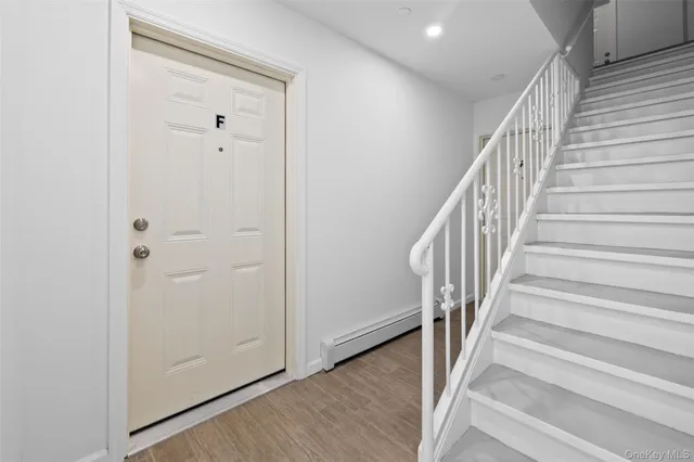 a view of an entryway with wooden floor
