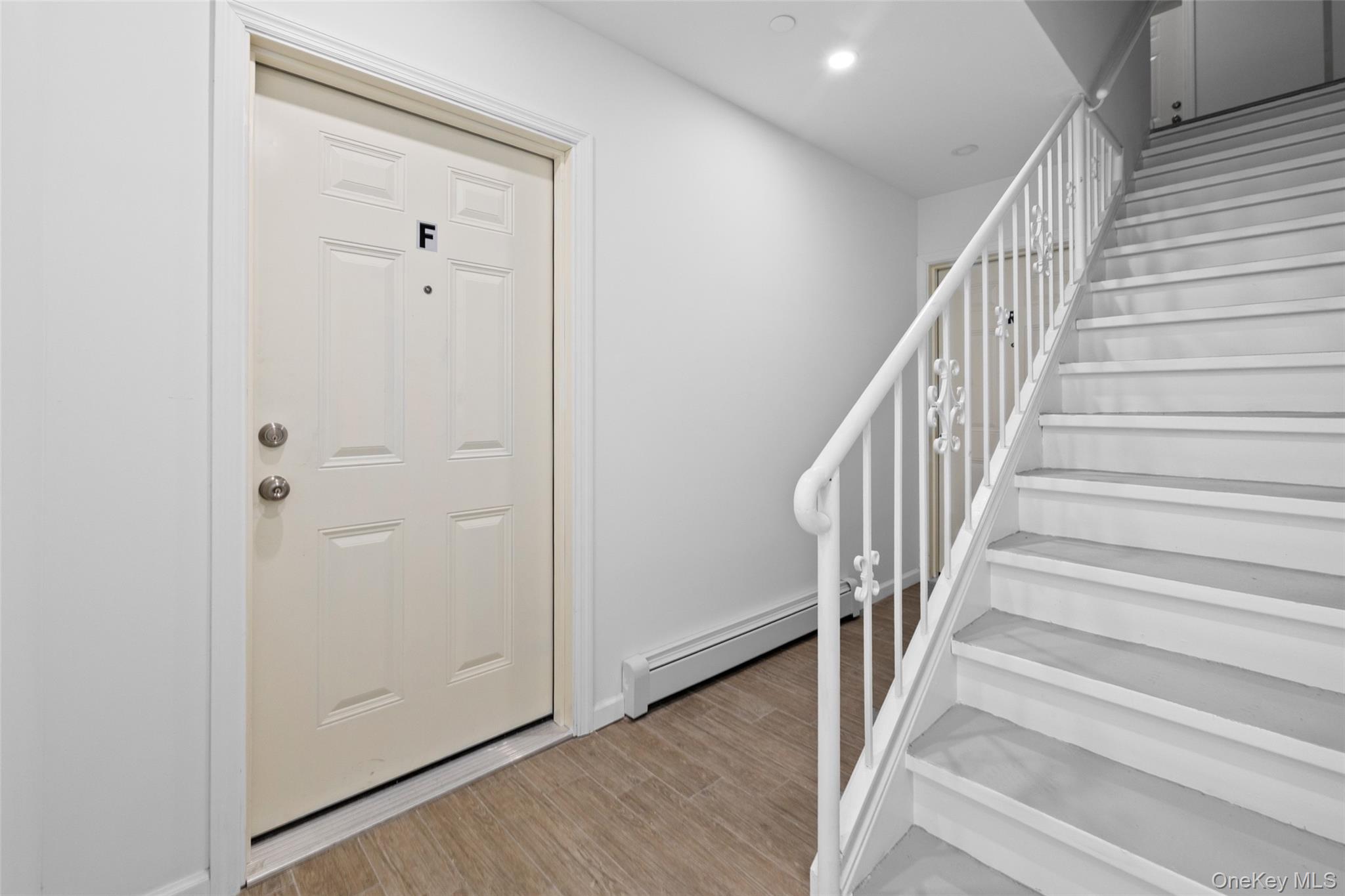 168-31 Hillside Avenue, Unit F Queens, NY 11432 - Photo 3 of 16 a view of an entryway with wooden floor