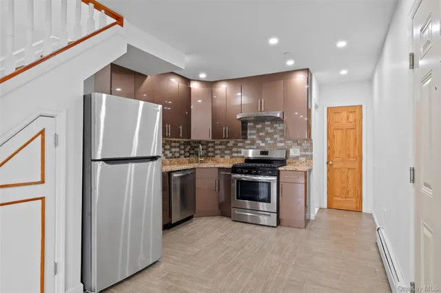 a kitchen with refrigerator a microwave and stove