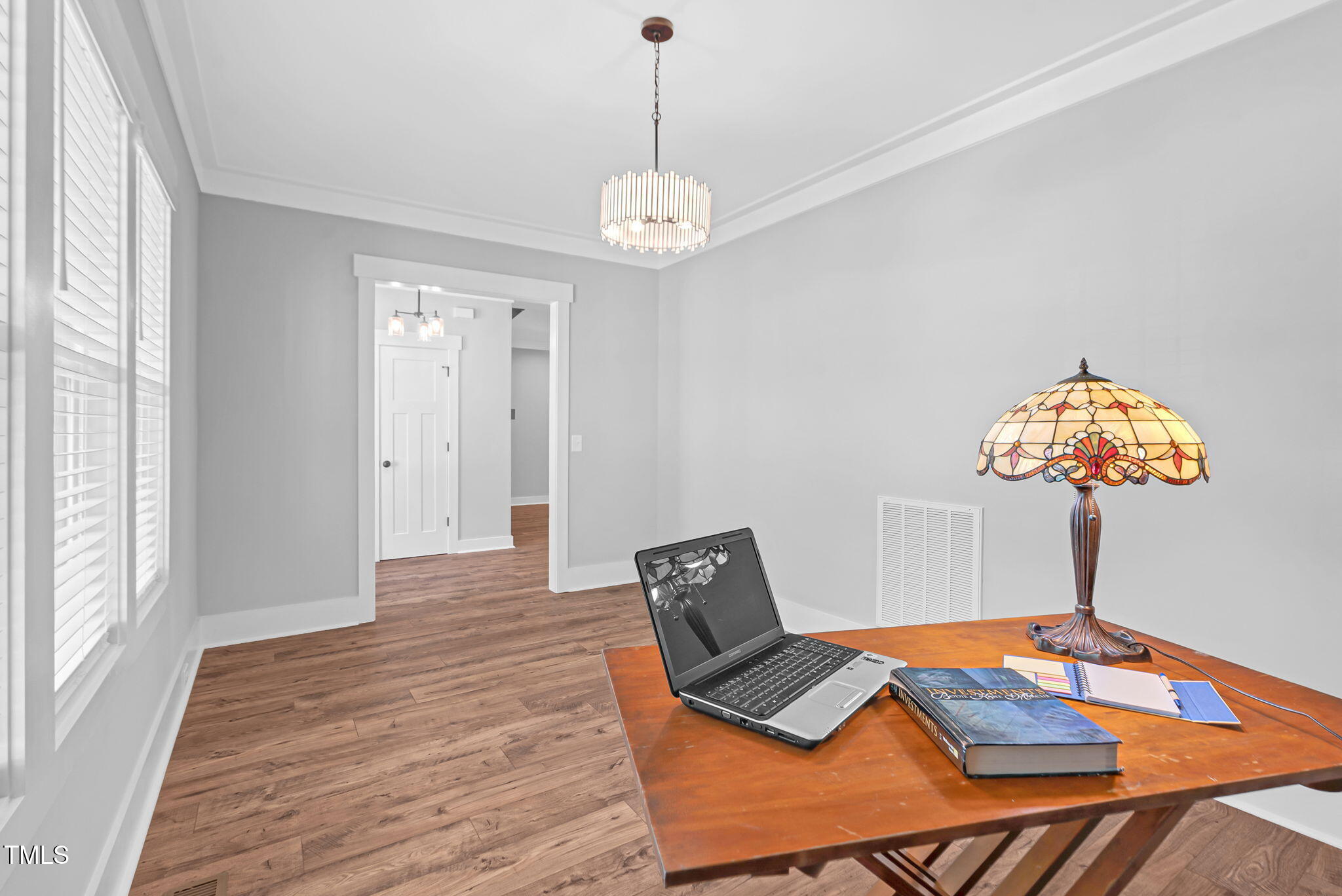 1004 Snow Peak Court Raleigh, NC 27603 - Photo 14 of 65 a bedroom with a bed and a chandelier