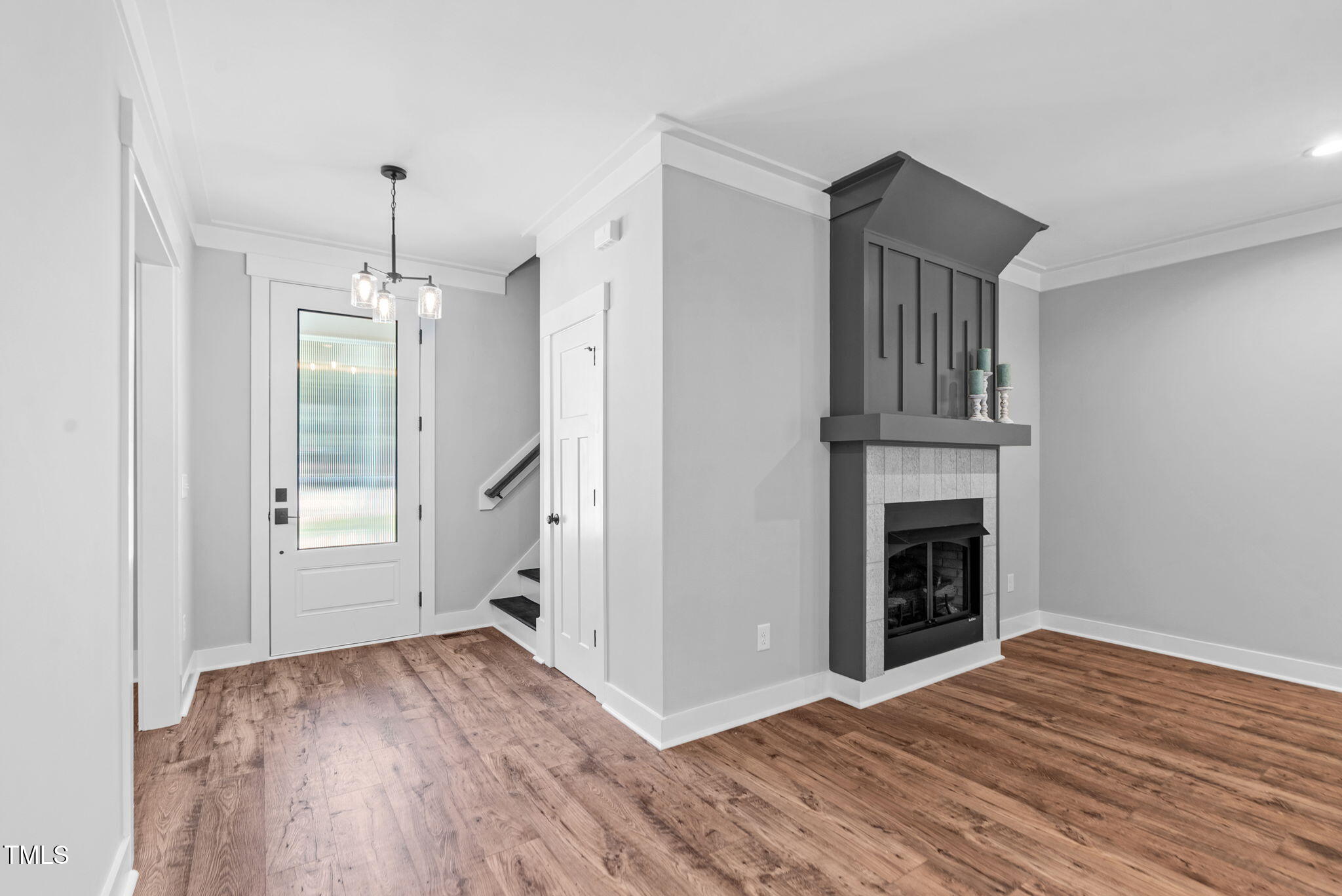 1004 Snow Peak Court Raleigh, NC 27603 - Photo 16 of 65 a view of empty room with wooden floor and fireplace