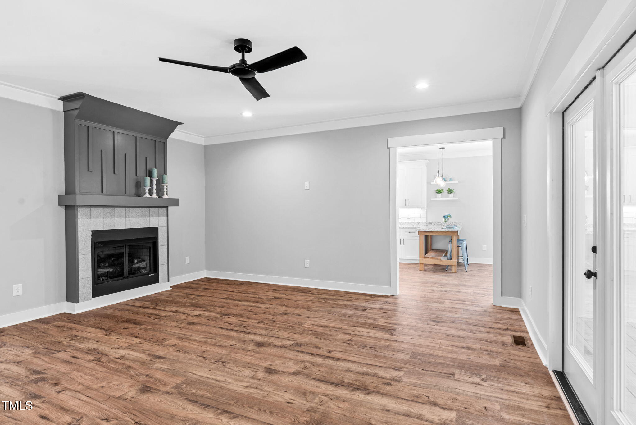 1004 Snow Peak Court Raleigh, NC 27603 - Photo 18 of 65 a view of empty room with wooden floor and a fireplace