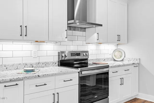 a bathroom with a granite countertop sink and mirror