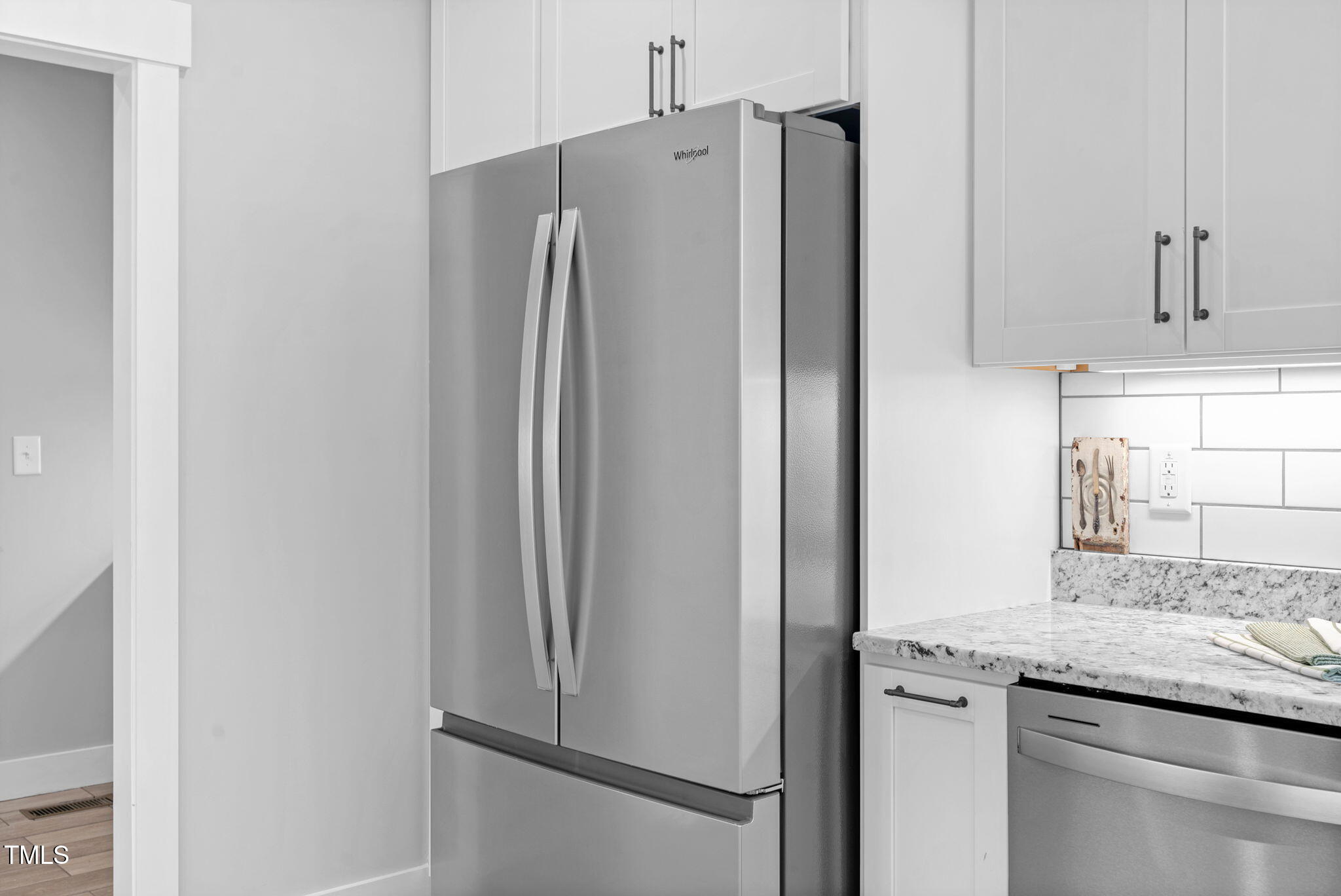1004 Snow Peak Court Raleigh, NC 27603 - Photo 30 of 65 a kitchen with stainless steel appliances granite countertop a refrigerator and a sink