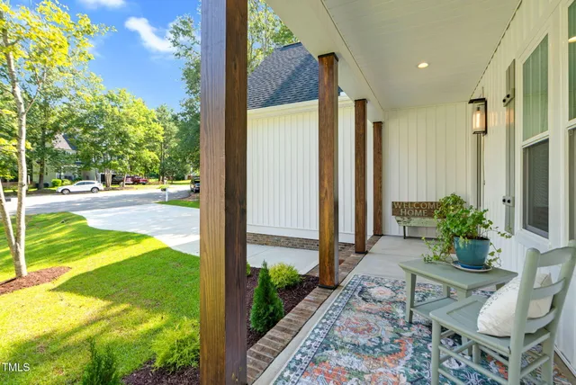 a porch with a table and chairs in patio