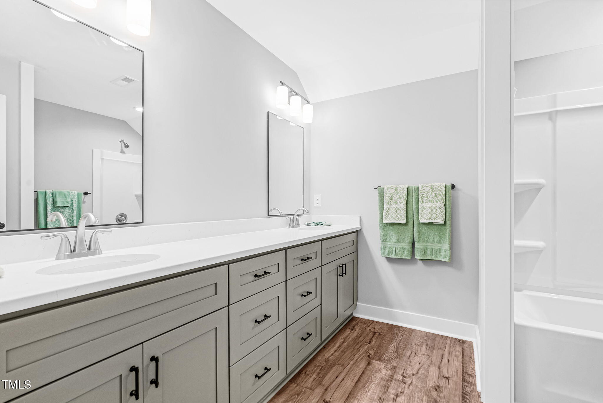1004 Snow Peak Court Raleigh, NC 27603 - Photo 50 of 65 a spacious bathroom with double vanity and a mirror
