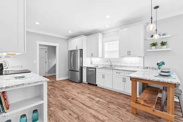 a kitchen with a sink stove and refrigerator