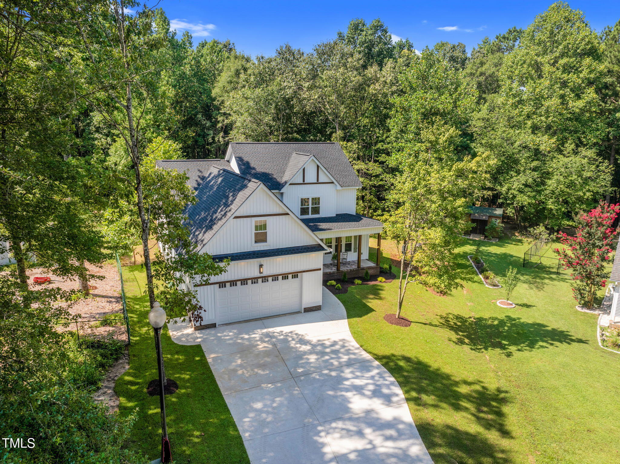 1004 Snow Peak Court Raleigh, NC 27603 - Photo 63 of 65 a view of a house with a big yard and large trees