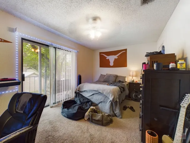 a bedroom with furniture and a closet