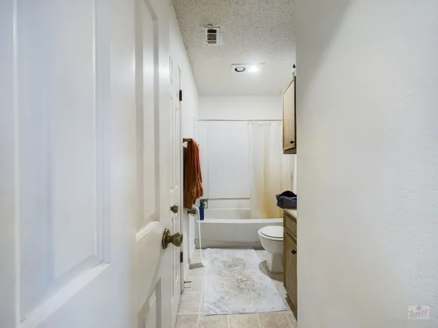 a bathroom with a sink a toilet and a tub