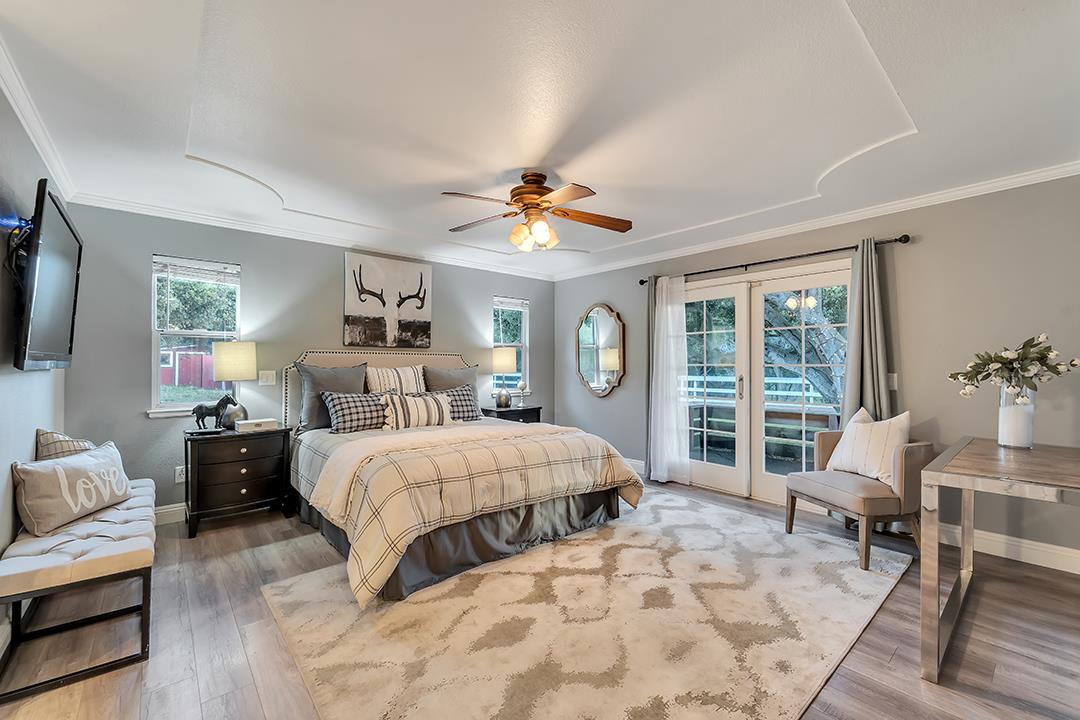 8640 Dyer Road Prunedale, CA 93907 - Photo 28 of 61 a bedroom with a large bed a flat screen tv and a large window