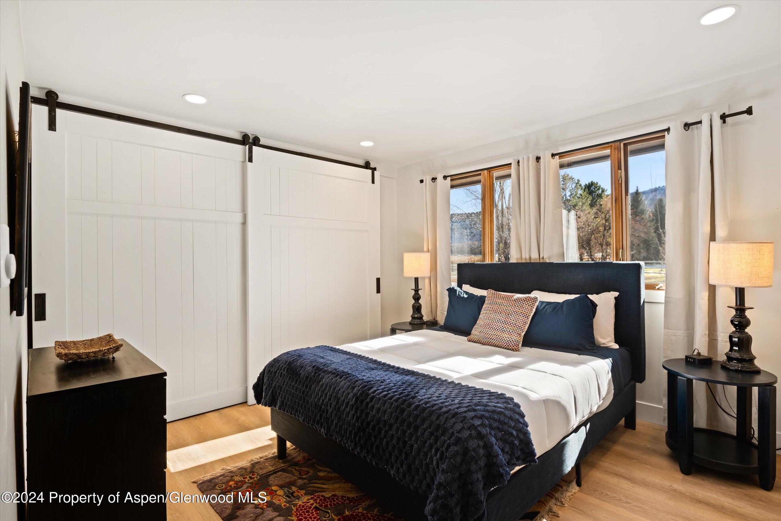 24 Cherry Lane Basalt, CO 81621 - Photo 14 of 42 a bedroom with a bed and wooden floor